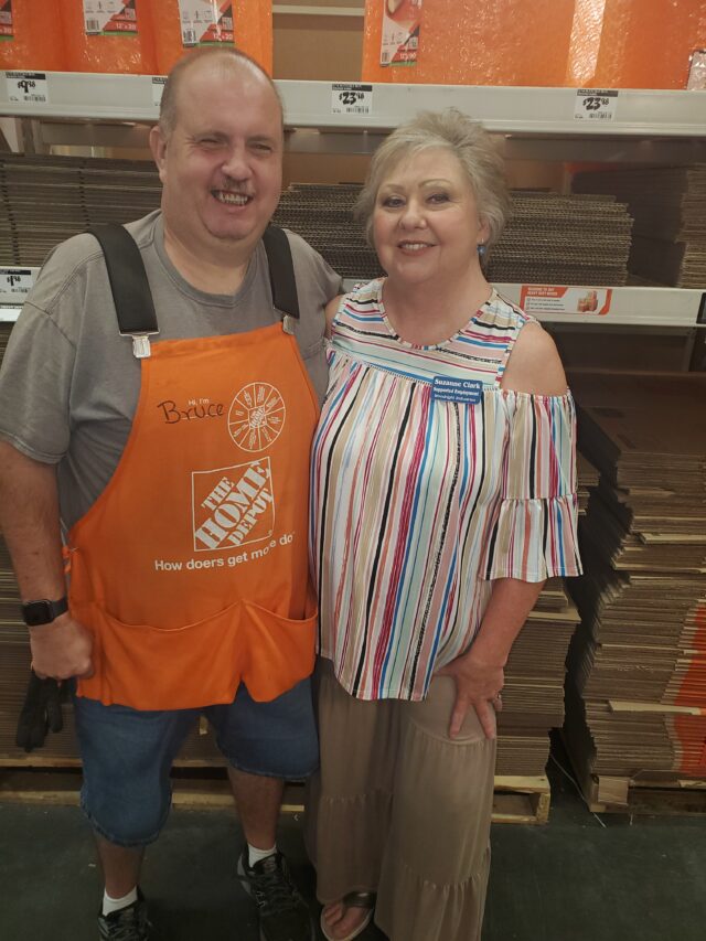 Bruce Arnold, while working a shift at The Home Depot, stands next to his supervisor.