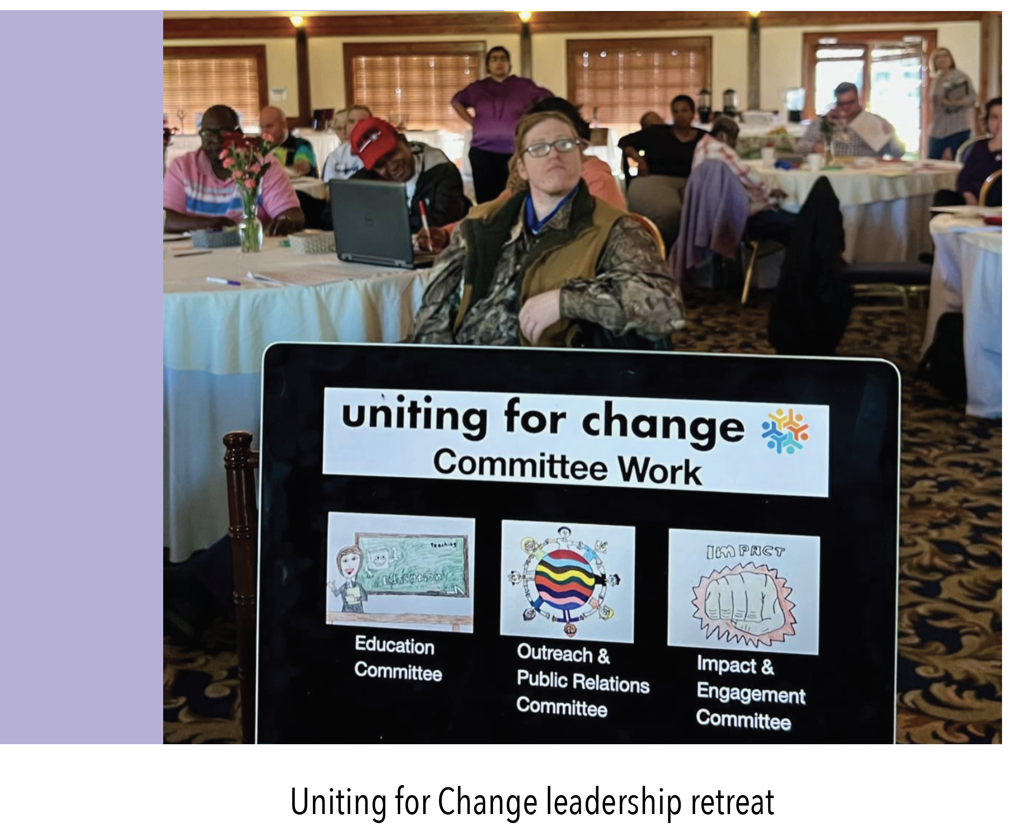 Disabled person with a banner that reads: UNITING FOR CHANGE LEADERSHIP RETREAT