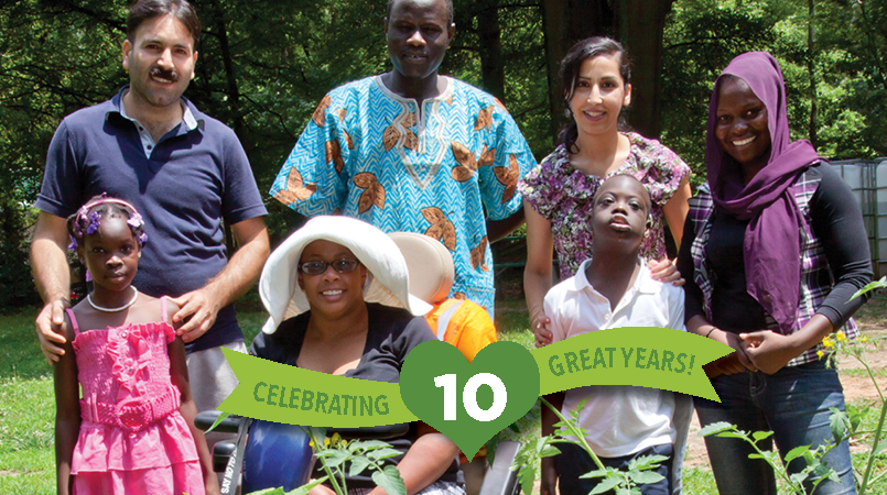 Green banner with photo of seven people posing together for a photo in a garden on the right side.